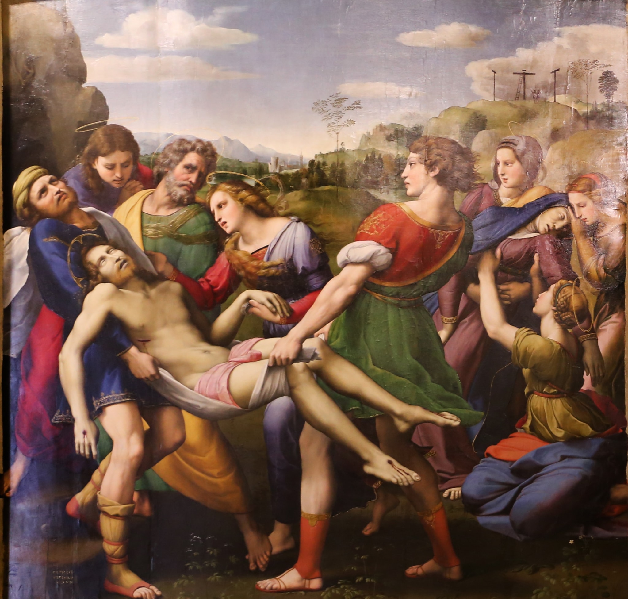 Mary Magdalene, in lavender and red, leans toward Christ and supports his left hand as the bearers carry his body. At the right, women tend the fainting Virgin.
