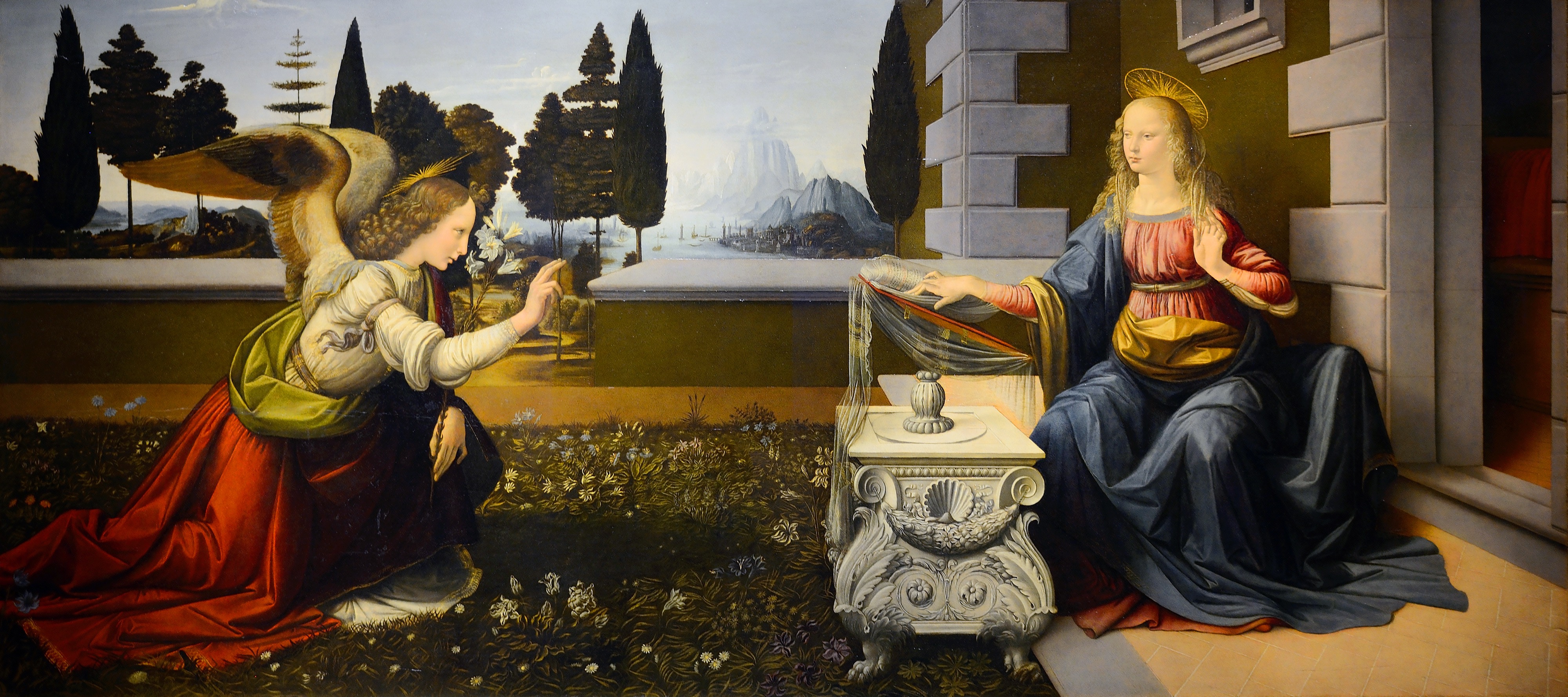 Gabriel kneels with a lily in a walled garden as Mary raises a hand beside an open book on a carved lectern.