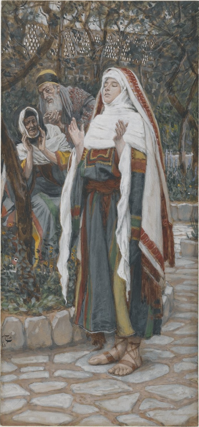 Mary stands with both hands raised in prayer in a leafy garden, with Elizabeth and Zechariah watching from behind.