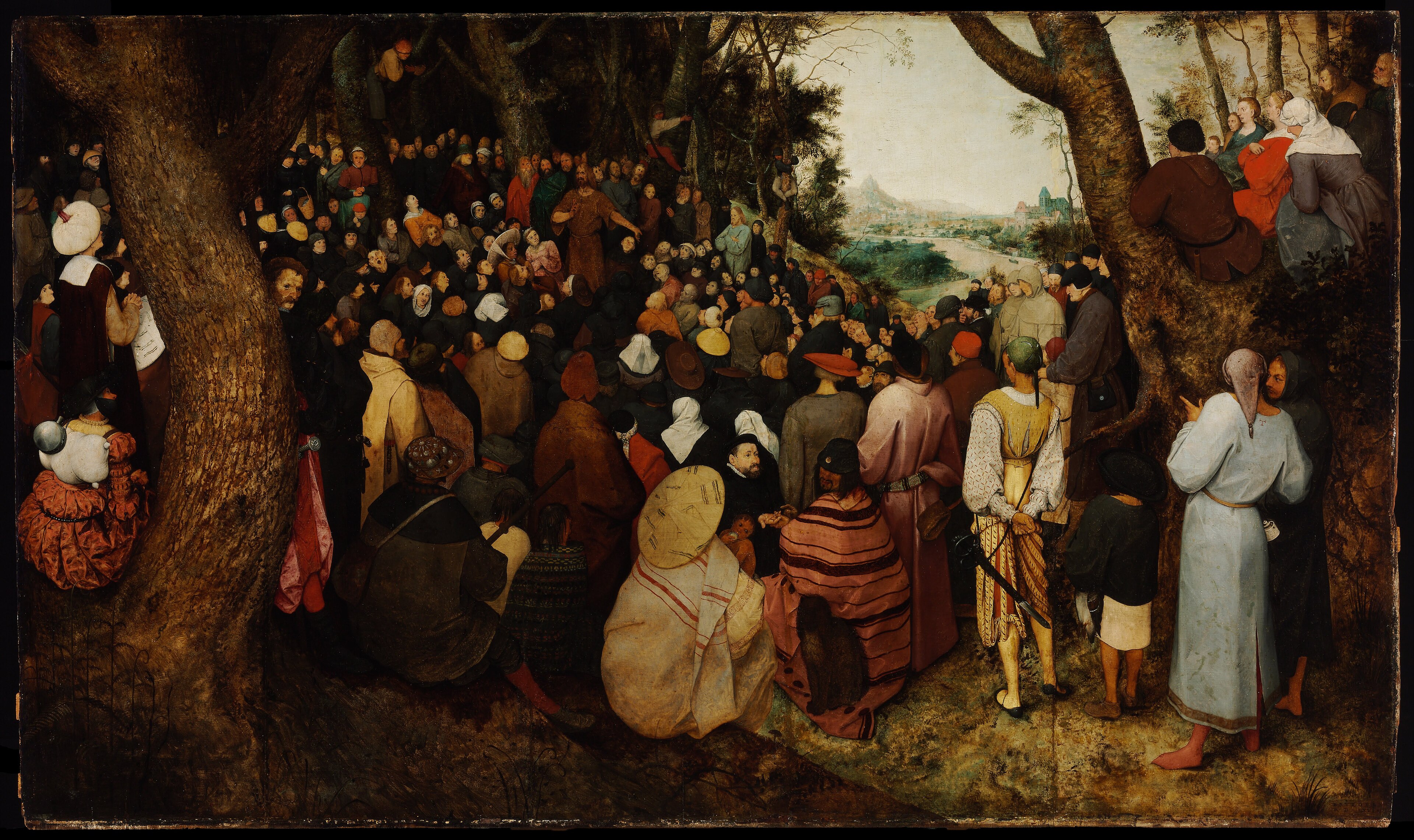 A large crowd gathers beneath trees to hear John preaching, with a distant river and landscape opening behind them.