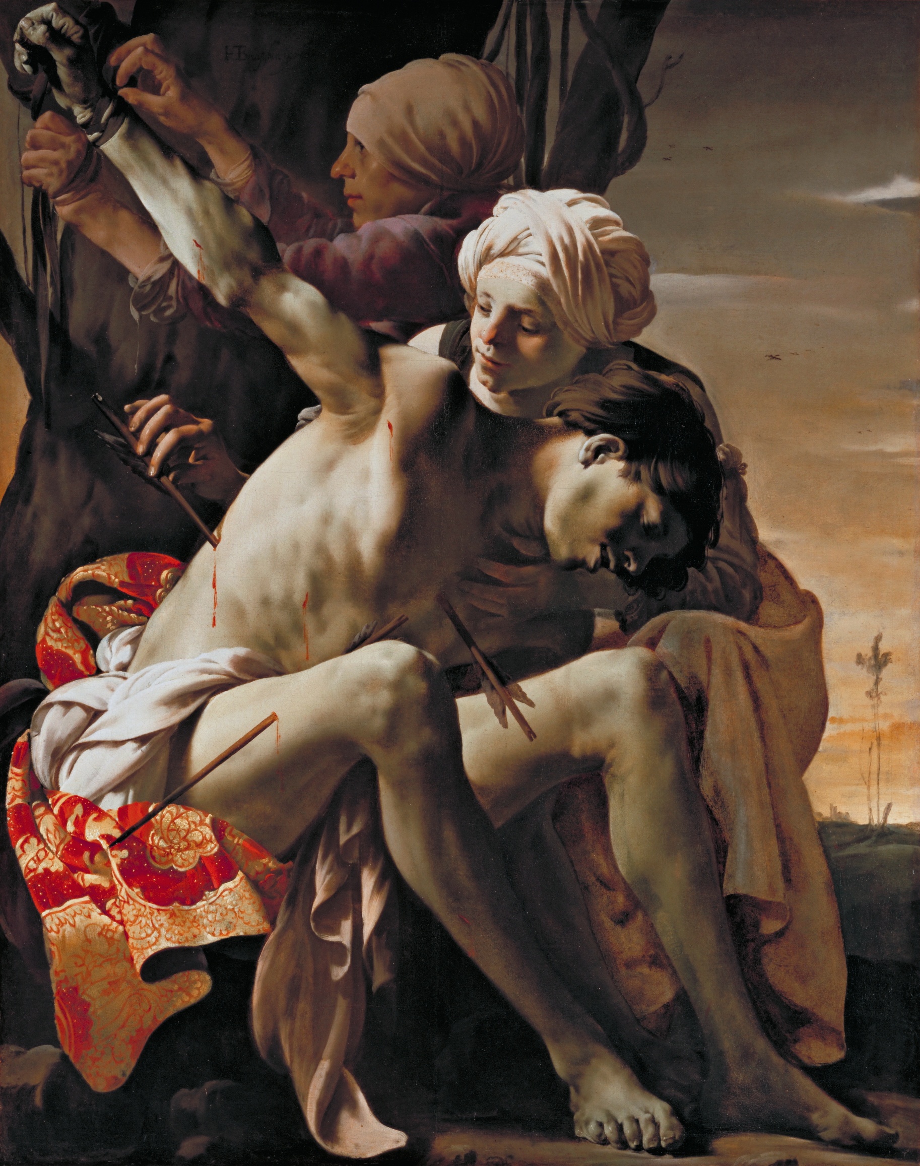 Two women support Sebastian as his body slumps forward, one working at his raised wrist while the other steadies him.