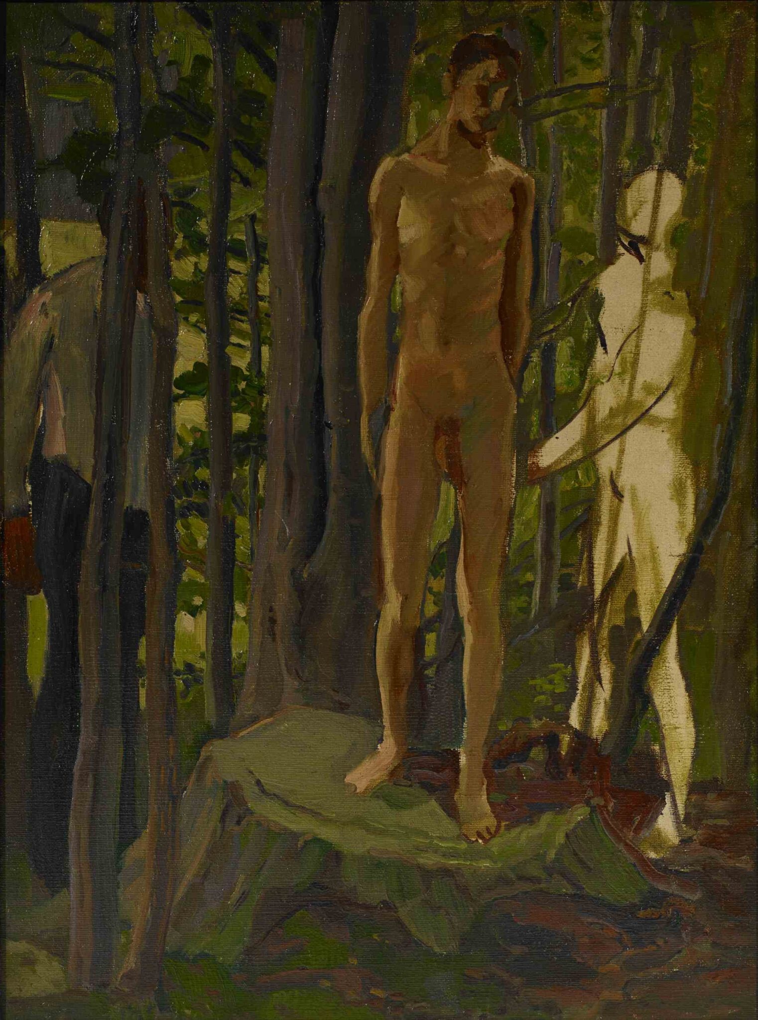 Sebastian stands barefoot on a broad tree stump among dense green and brown trees, with his head turned aside.