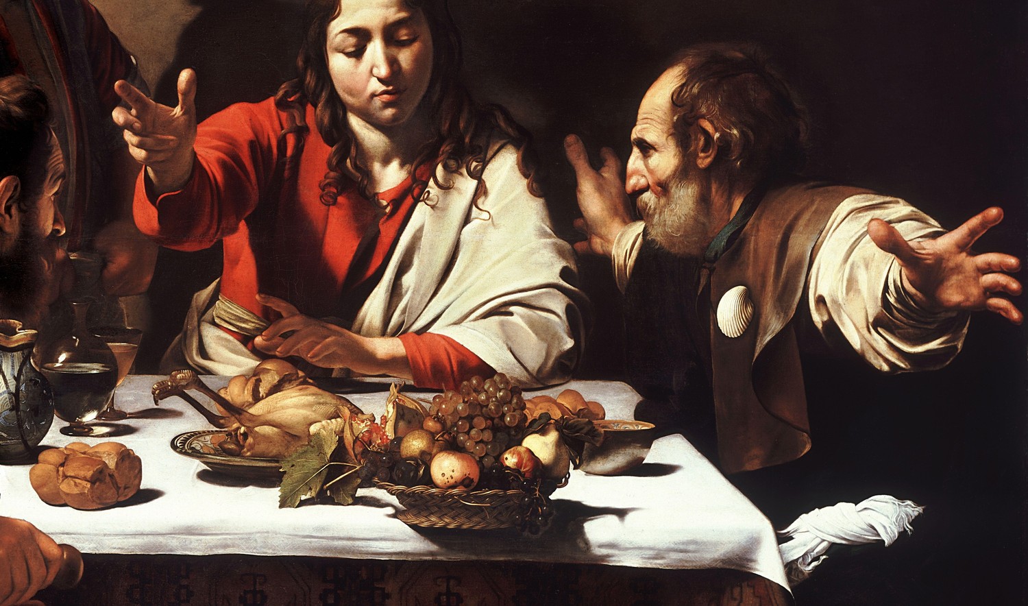 Detail of Supper at Emmaus by Caravaggio (1601): the hands of Jesus and two disciples around a table set with bread, fruit and a roast fowl. An example painting for Visio Divina at Easter.